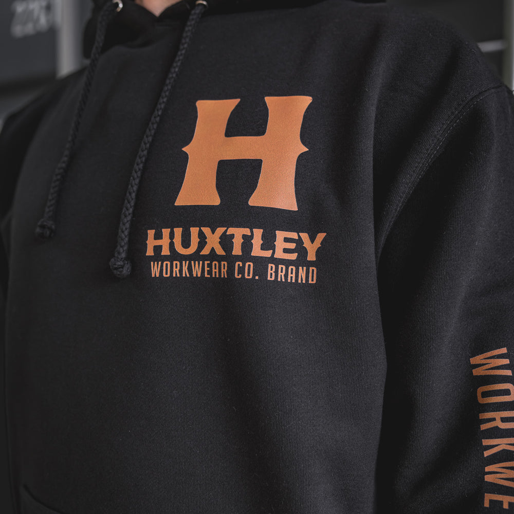 
                  
                    Zoomed-in view of the Full Print Hoodie featuring the bold chest “H” and sleeve branding in orange on black. Built for the trades, styled for everyday wear.
                  
                