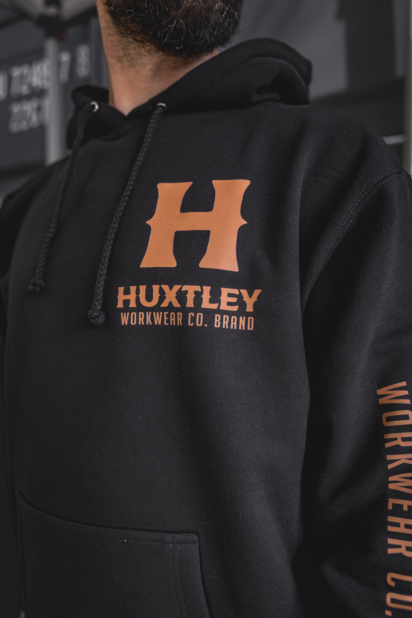 
                  
                    Zoomed-in view of the Full Print Hoodie featuring the bold chest “H” and sleeve branding in orange on black. Built for the trades, styled for everyday wear.
                  
                