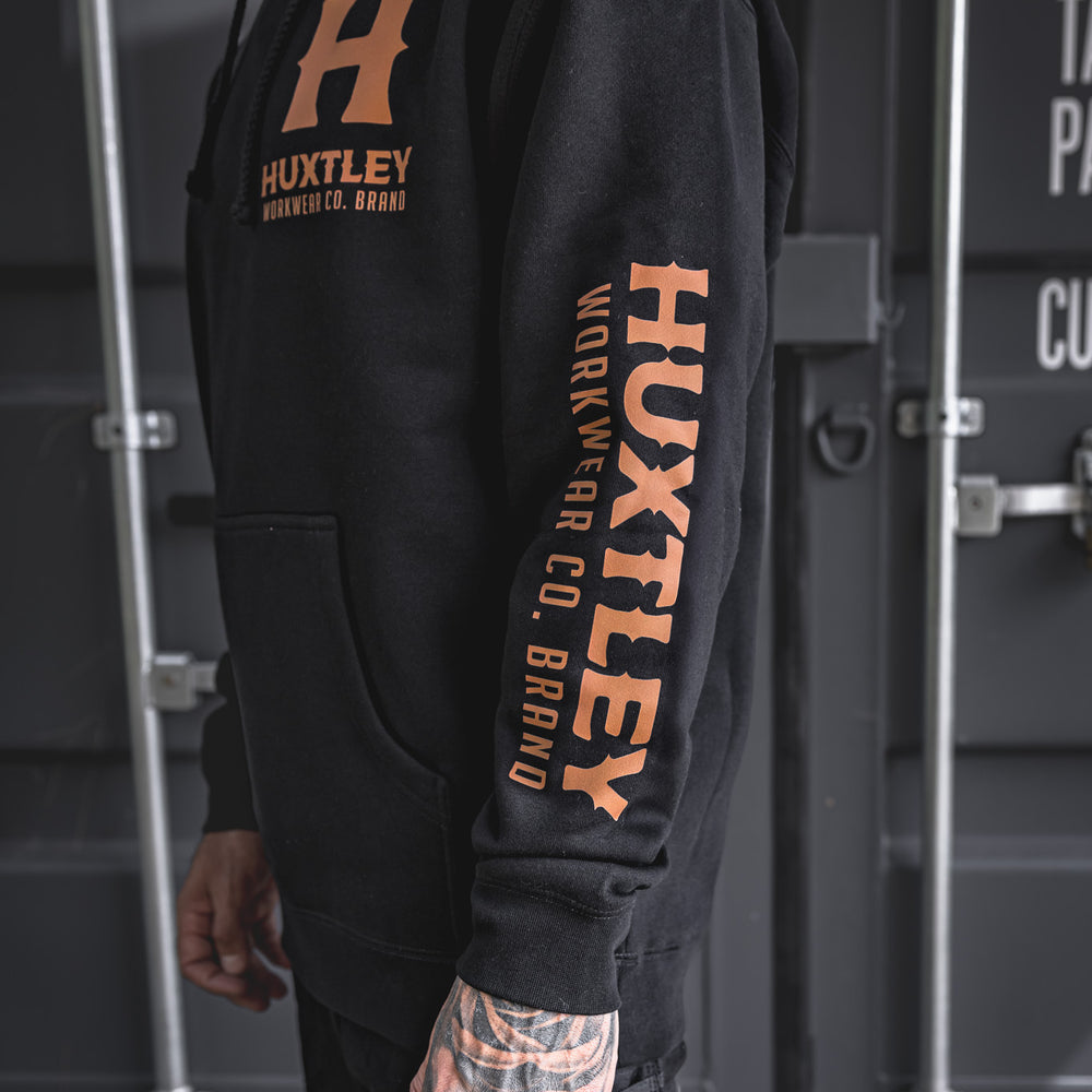 
                  
                    Side angle of the Full Print Hoodie featuring Huxtley branding on the chest and down the sleeve. Built for rugged workdays, styled for pride.
                  
                