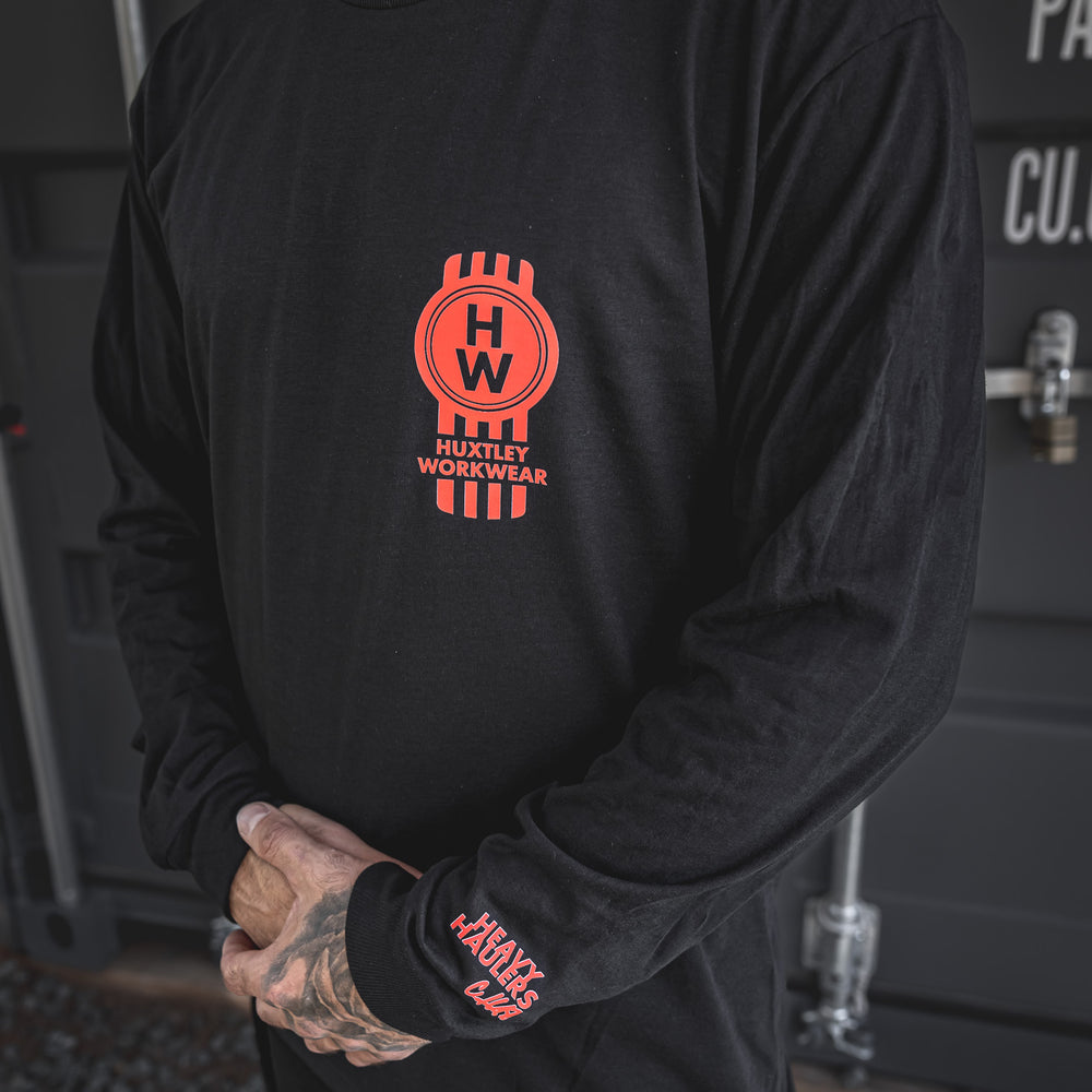 
                  
                    Bold red “HW” piston logo on chest and “Heavy Haulers Club” hit on the sleeve. Built for rig riders, shop dogs, and long haul legends.
                  
                