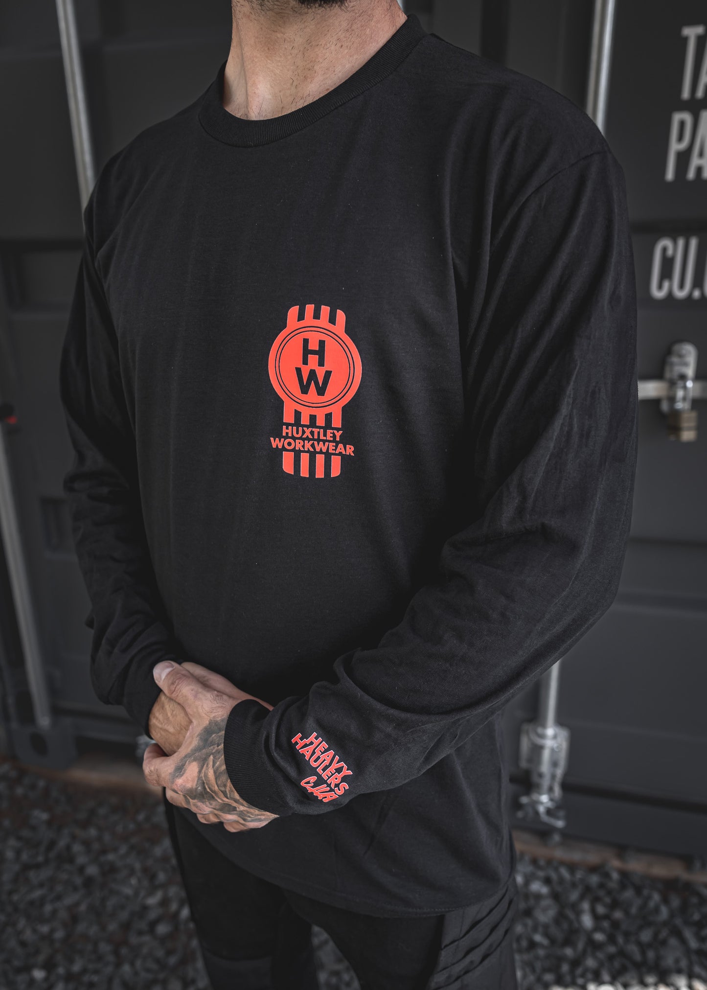 
                  
                    Bold red “HW” piston logo on chest and “Heavy Haulers Club” hit on the sleeve. Built for rig riders, shop dogs, and long haul legends.
                  
                