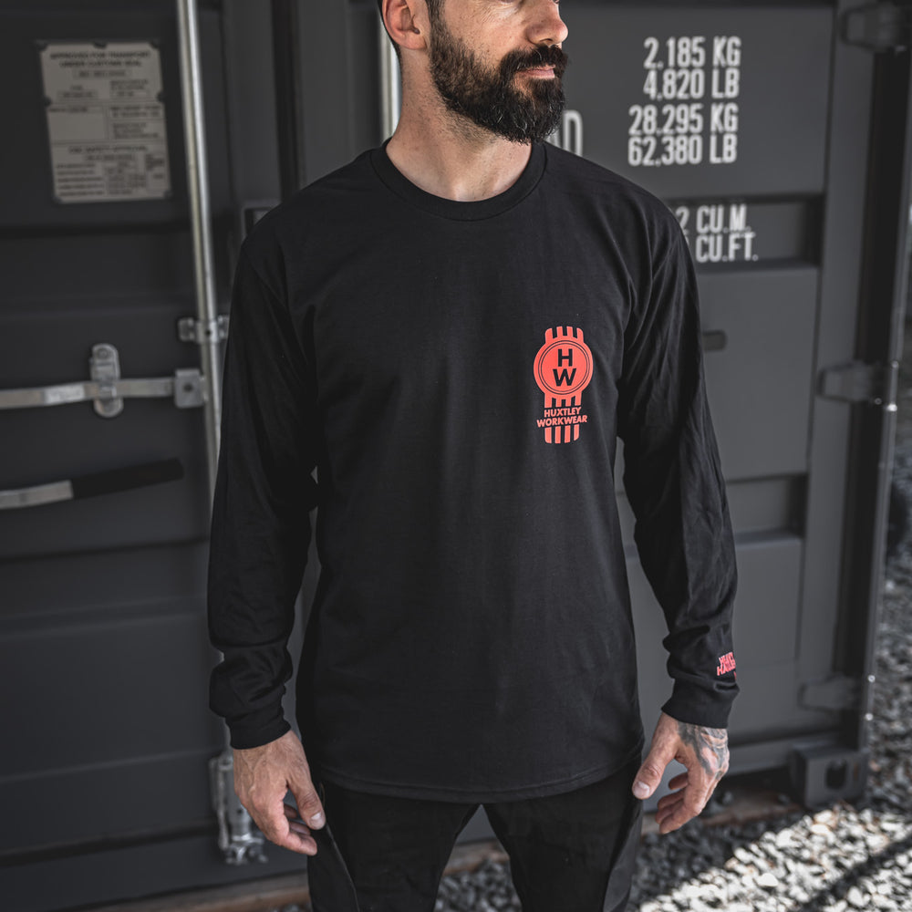 
                  
                    Front chest hit features the red “HW” piston emblem and “Heavy Haulers Club” sleeve detail. Long sleeve built for hard-driving haulers and jobsite lifers.
                  
                