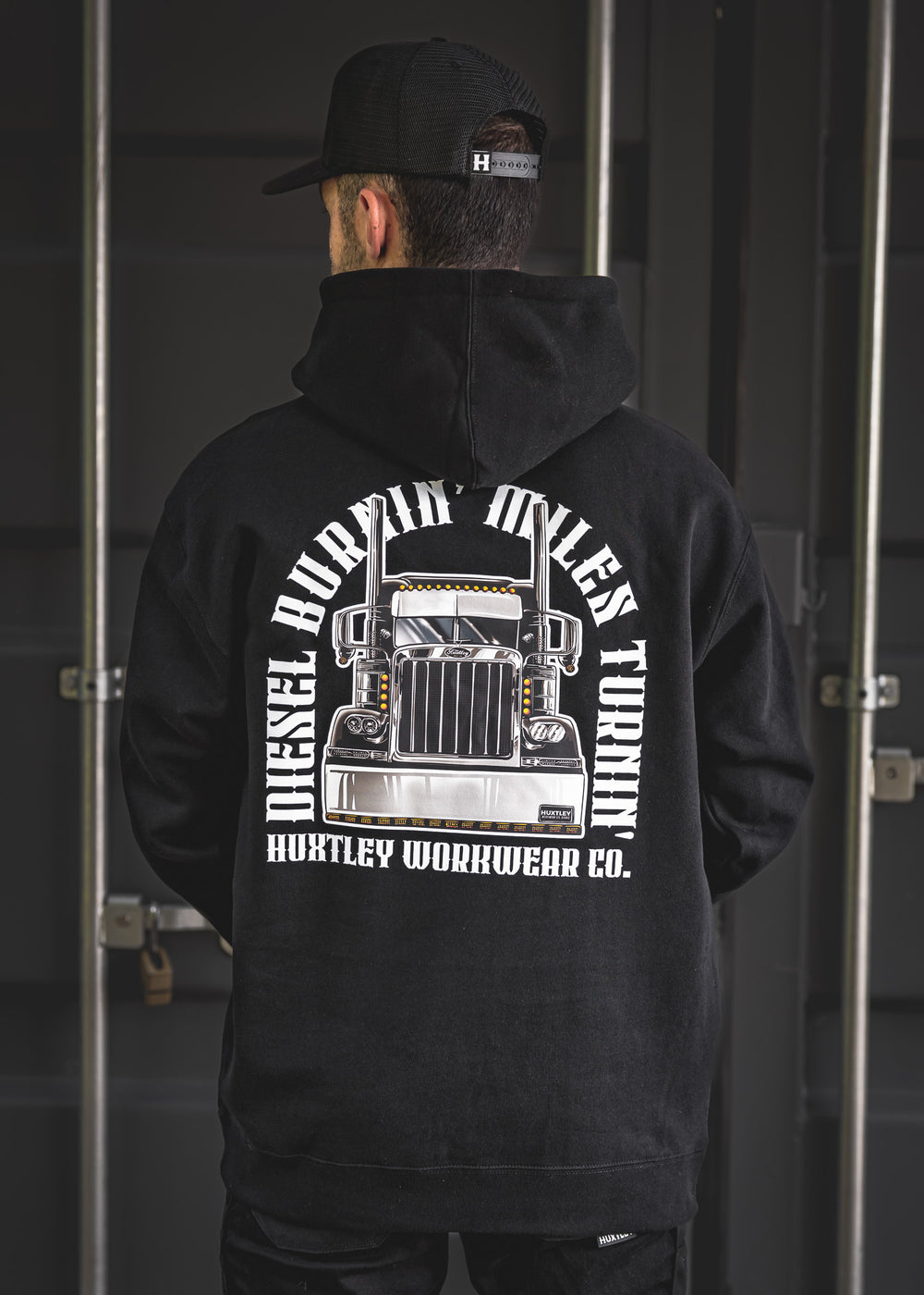 Black hoodie with large back print featuring a chrome big rig and bold “Diesel Burnin’, Miles Turnin’” slogan. Built for truckers, haulers, and hard-hustling crews.