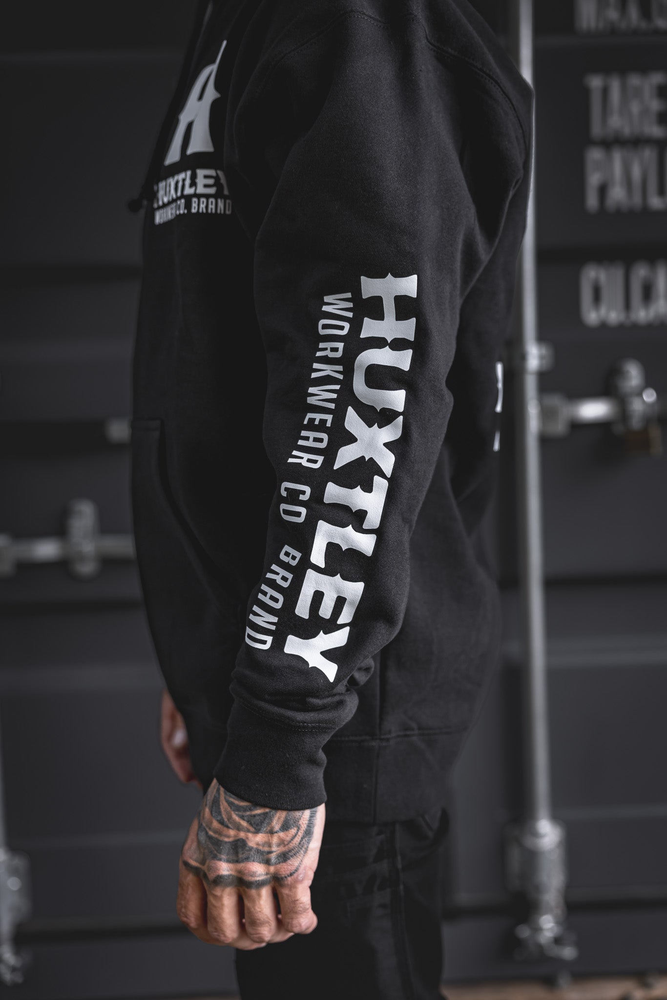 
                  
                    Close-up of the right arm on the Full Print Hoodie in white. Oversized HUXTLEY print down the sleeve keeps it loud and proud. Built for trades.
                  
                