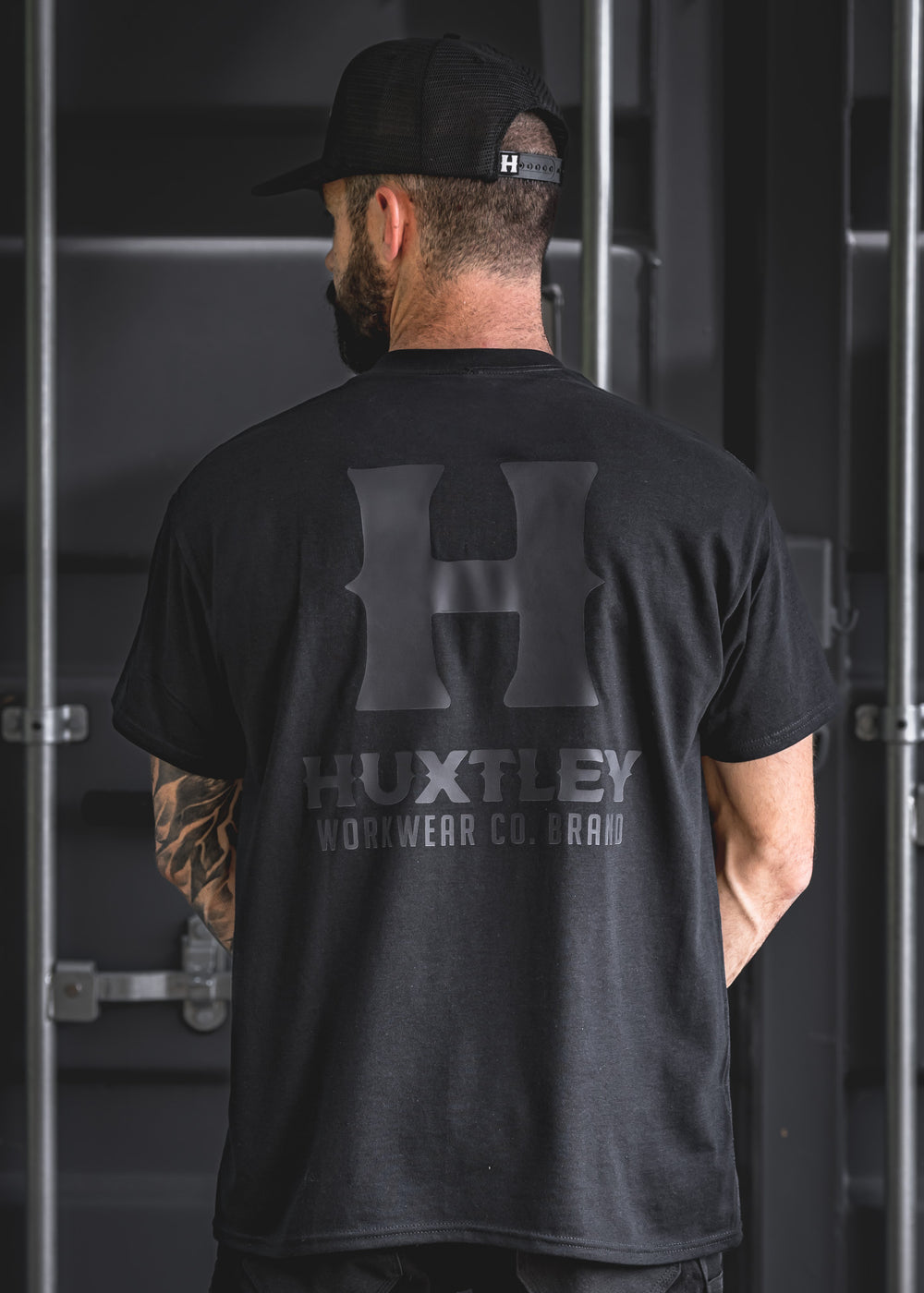 Back design of the Huxtley Full Print tee featuring the stealthy blackout logo. Clean, tonal branding made for the trades.