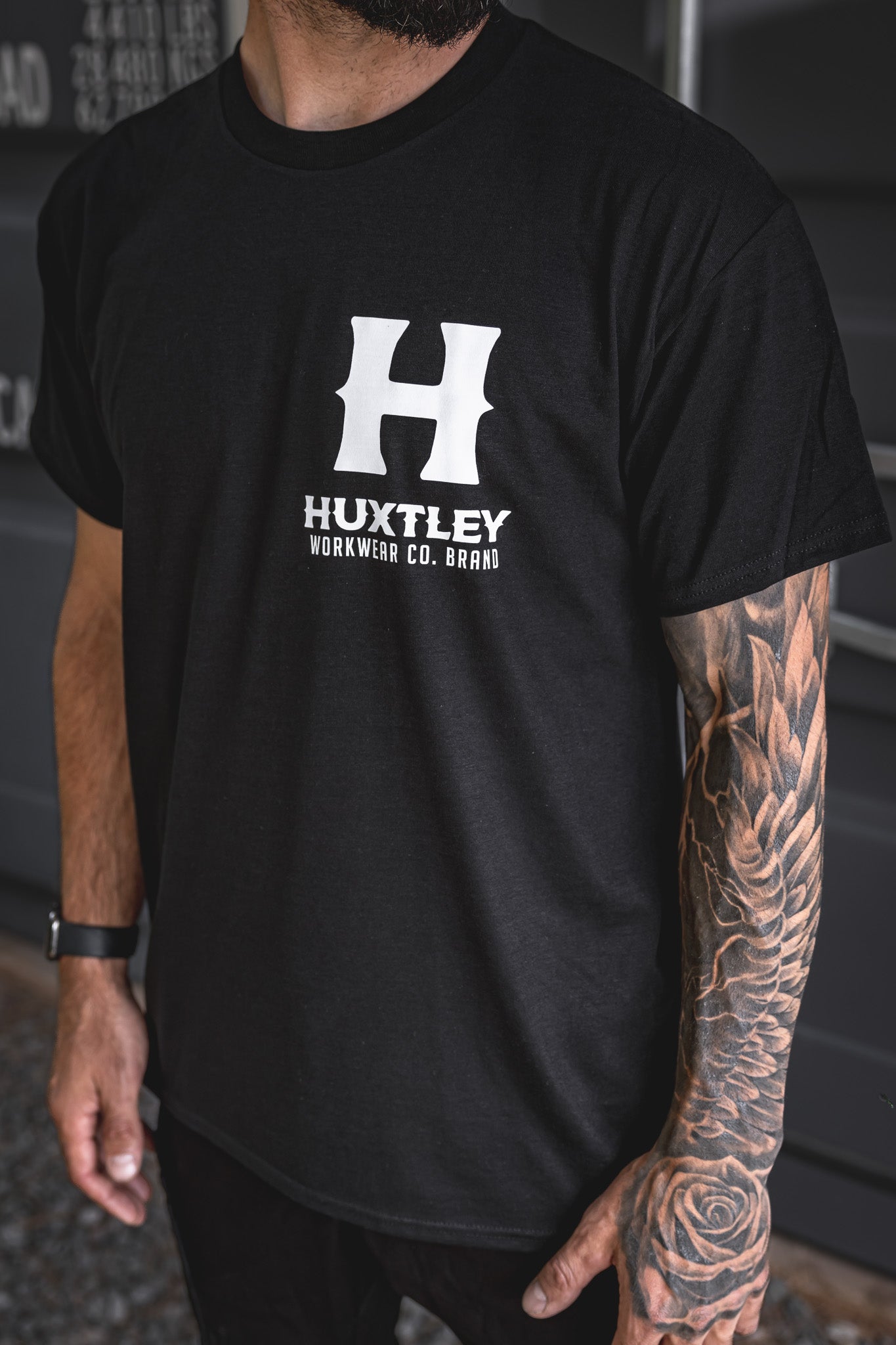 
                  
                    Close-up of the Huxtley Full Print tee featuring the bold white logo on the chest. Built tough with standout contrast.
                  
                