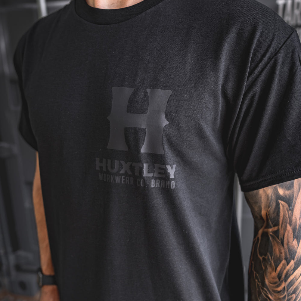 
                  
                    Detailed side angle of the Huxtley Full Print T-shirt with blackout logo. A subtle flex built for hard wear and clean looks.
                  
                