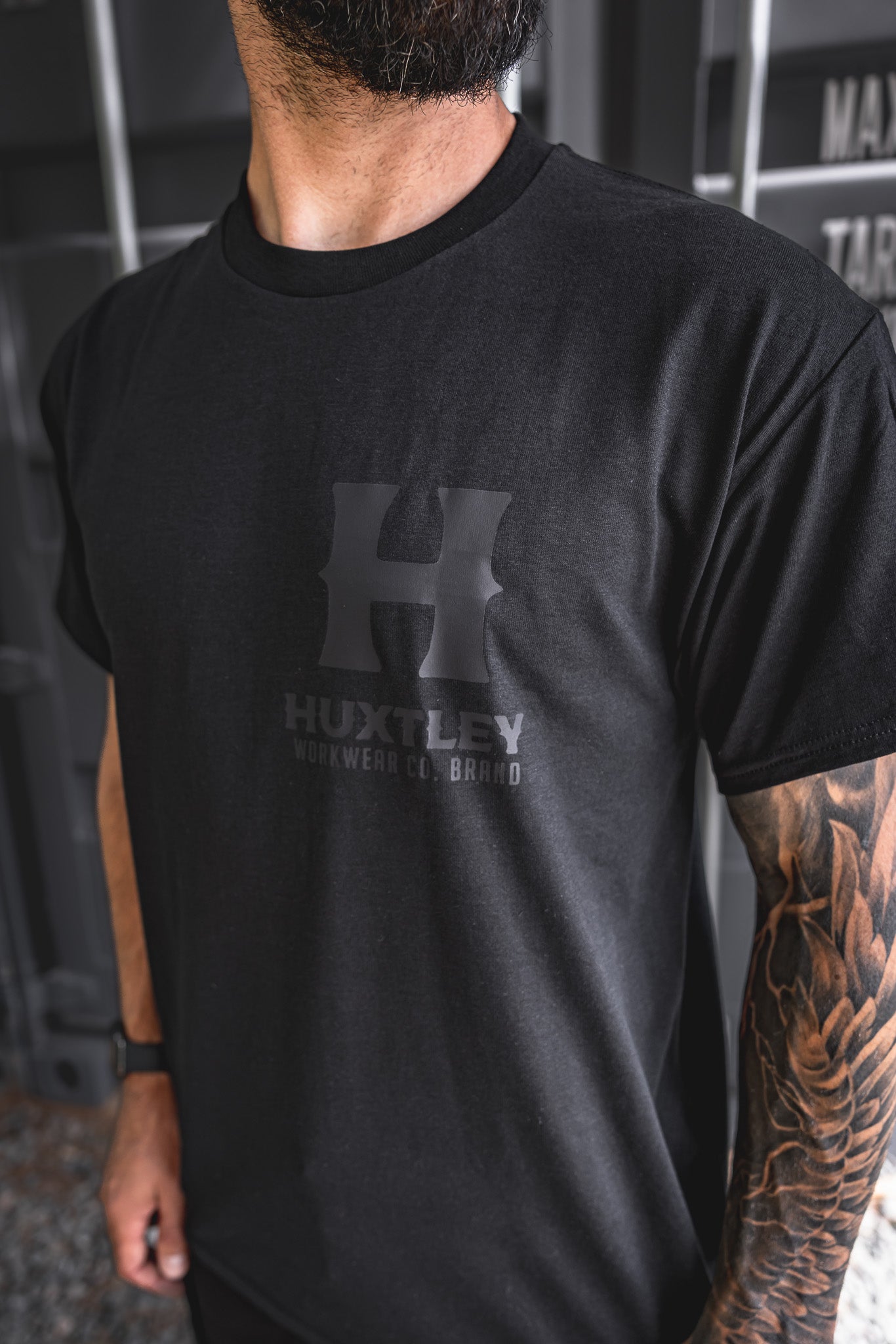 
                  
                    Detailed side angle of the Huxtley Full Print T-shirt with blackout logo. A subtle flex built for hard wear and clean looks.
                  
                