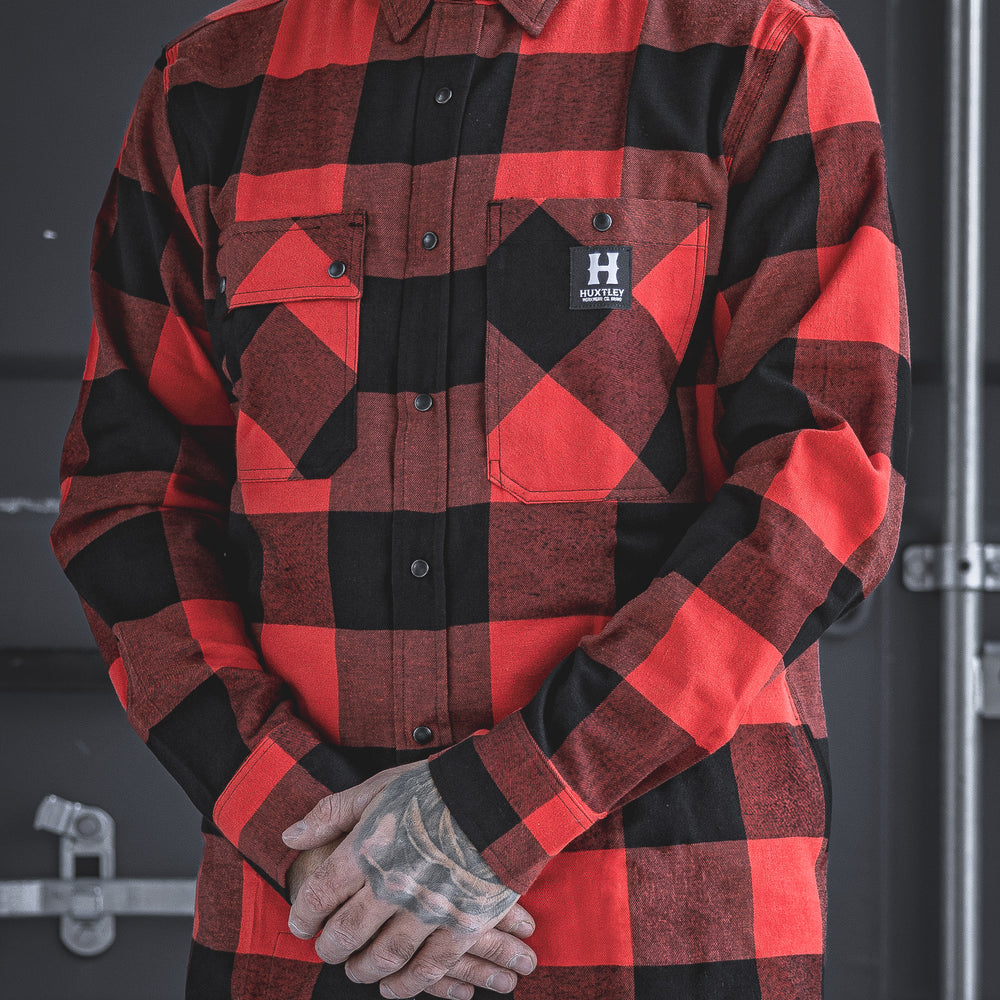 The Huxtley HD-57 Flannel in red/black brings rugged heritage to the modern jobsite. Tough, functional, and sharp-looking—this isn’t your dad’s flannel. Built for trades, styled for the streets.