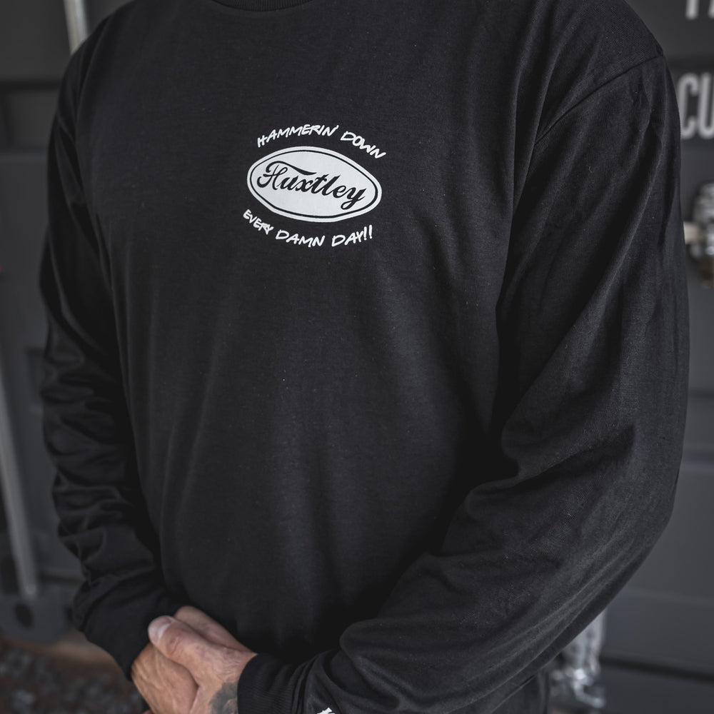 
                  
                    Close-up of the “Hammerin’ Down Every Damn Day!!” chest hit with retro Huxtley oval logo. Sleeve reads “Keep On Trucking” to keep the highway vibes rollin’.
                  
                