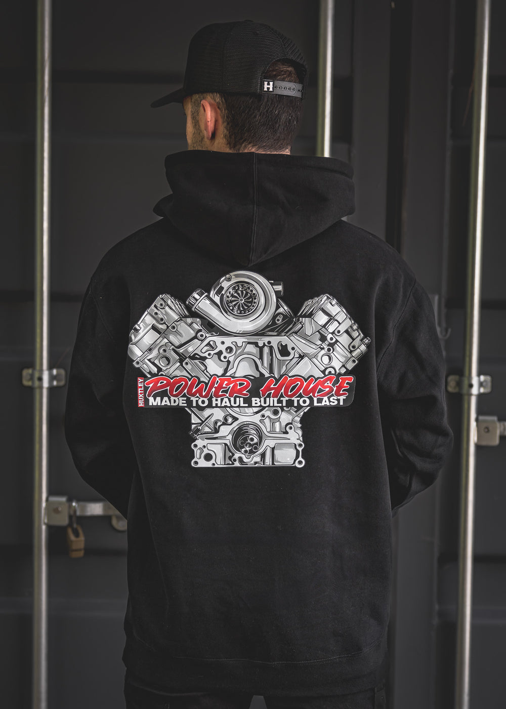 Black heavyweight hoodie featuring a turbocharged engine graphic and bold “POWER HOUSE – Made to Haul, Built to Last” print on the back. Warm, durable, and jobsite-tough.