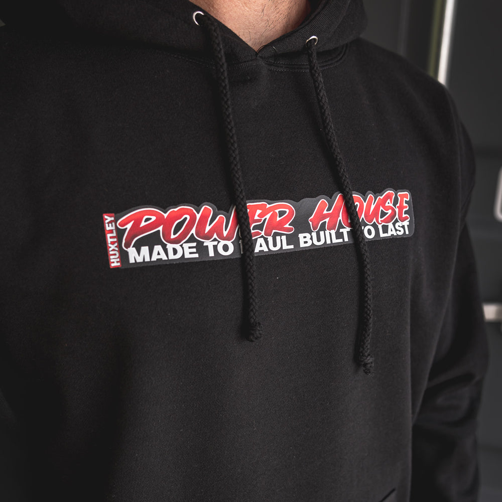 
                  
                    Detailed view of the “POWER HOUSE – Made to Haul, Built to Last” chest graphic on black Huxtley hoodie. Bold print, clean stitching, and built for rugged wear.
                  
                