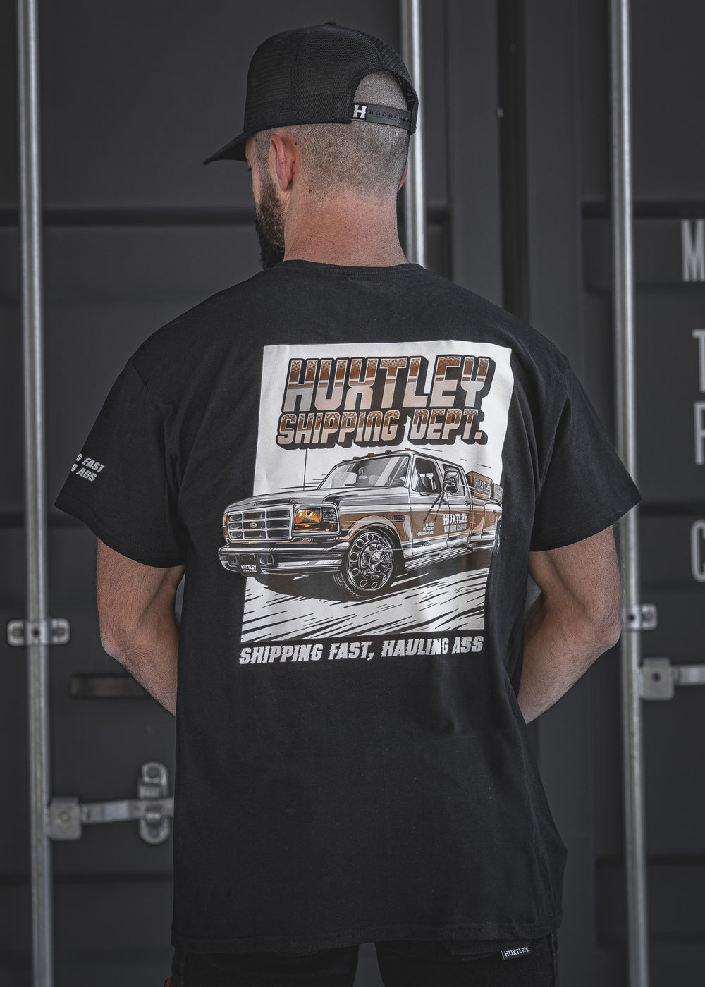 Back view of the Huxtley Shipping Dept. short sleeve tee in black, featuring the signature vintage truck graphic and 