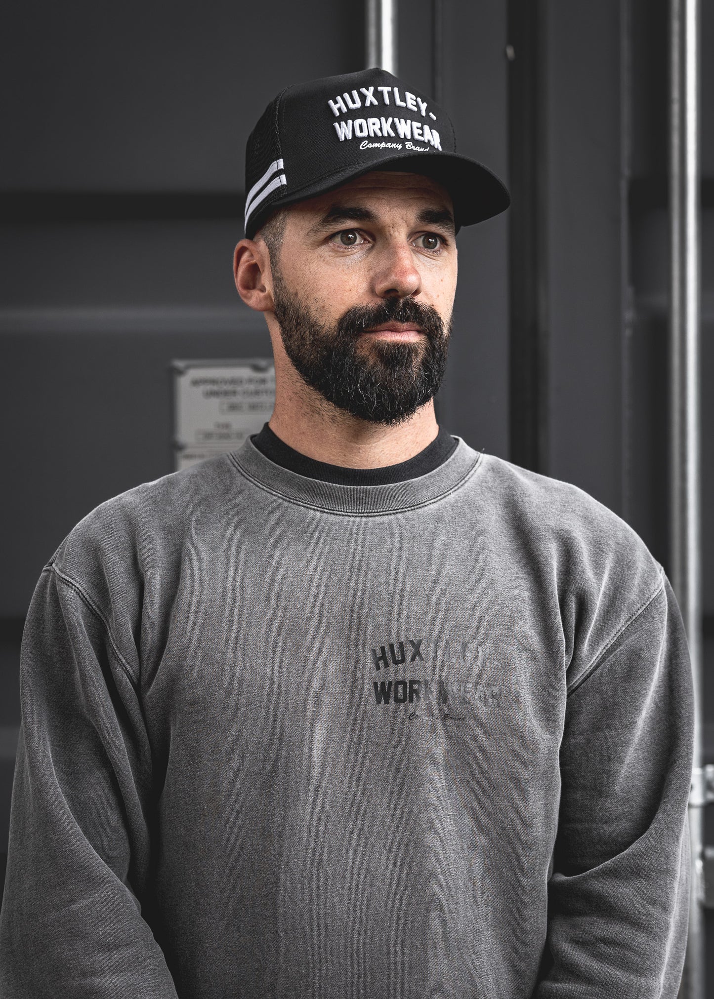 
                  
                    The Throwback cap brings vintage athletic stripes and bold Huxtley embroidery together. Worn here by a rugged model in a washed crewneck, this look hits hard on and off the clock.
                  
                