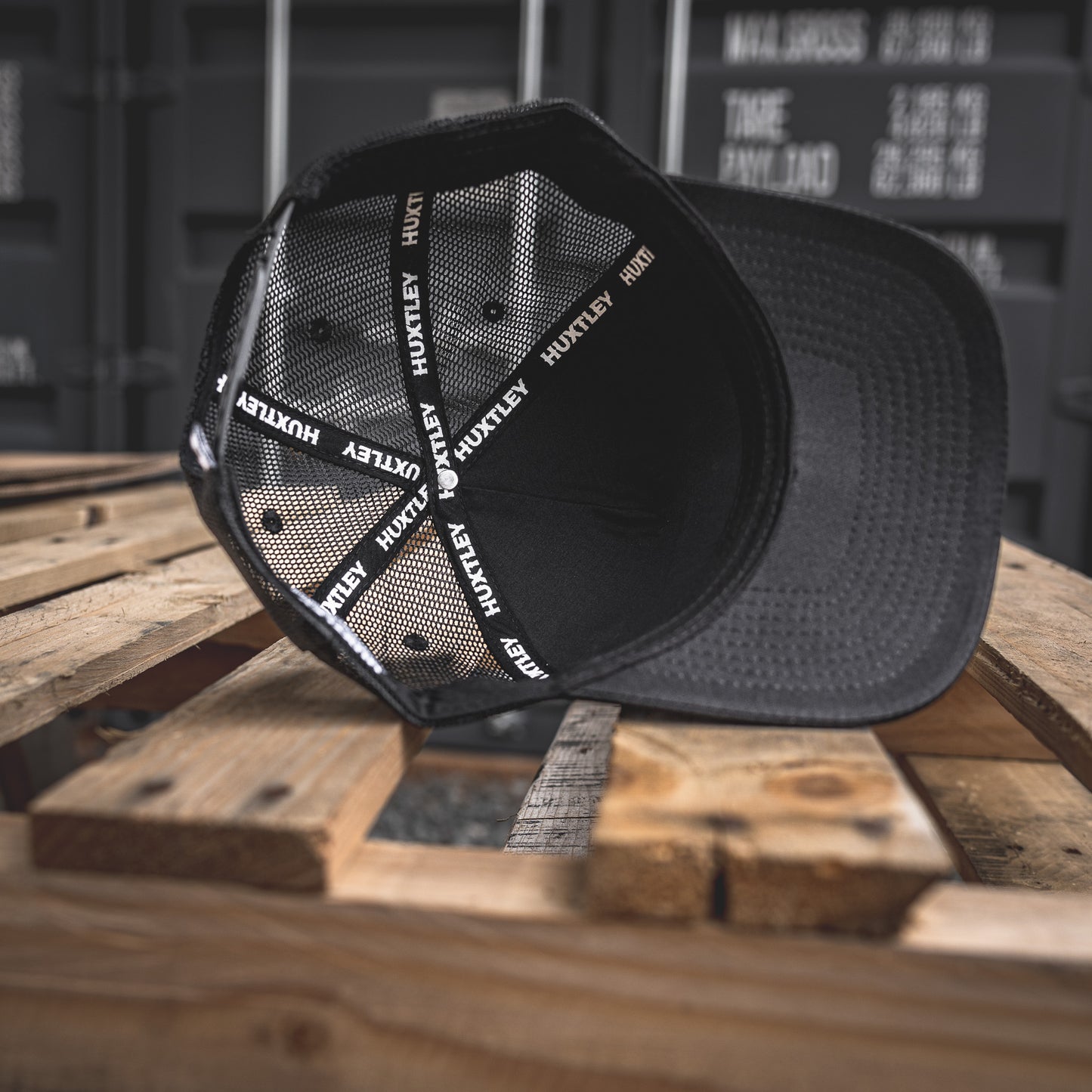 Close-up of the Huxtley cap’s inner construction: breathable mesh panels and bold logo taping. Tough build, clean finish.