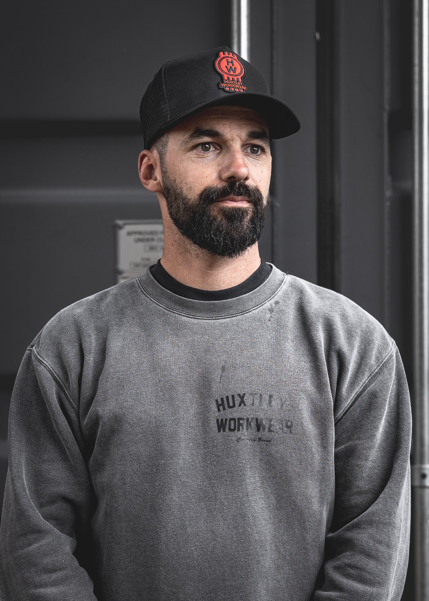 
                  
                    Bold and built for the grind. This Huxtley trucker cap features the standout red badge logo, breathable mesh panels, and a perfect fit for everyday jobsite wear.
                  
                