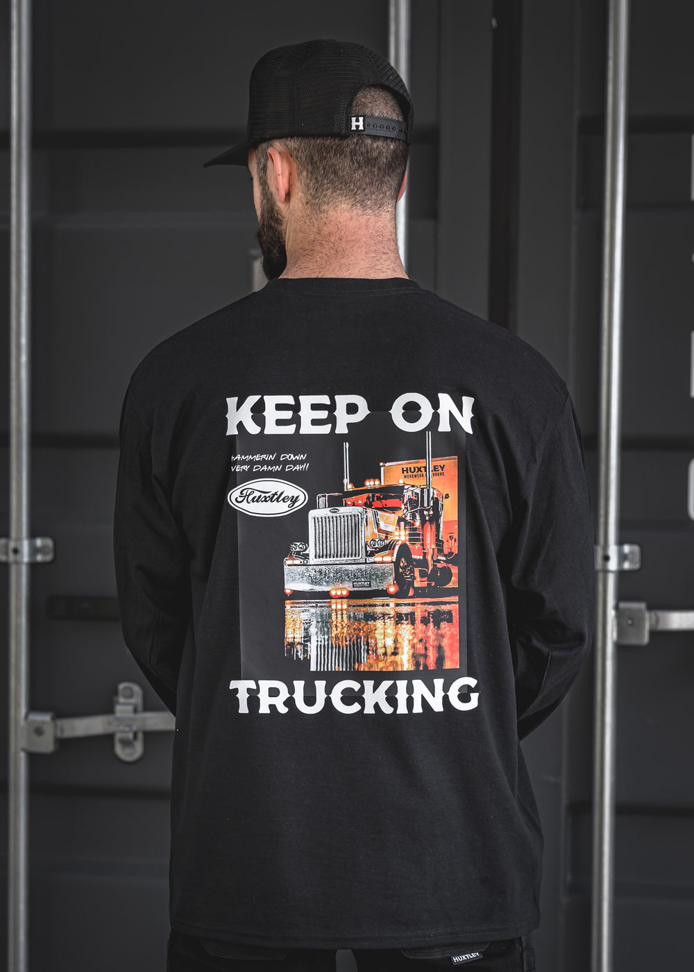 Back of the Huxtley long sleeve tee with retro “Keep On Trucking” graphic featuring a chrome rig under the lights. Built tough for haulers, hustlers, and hard days.